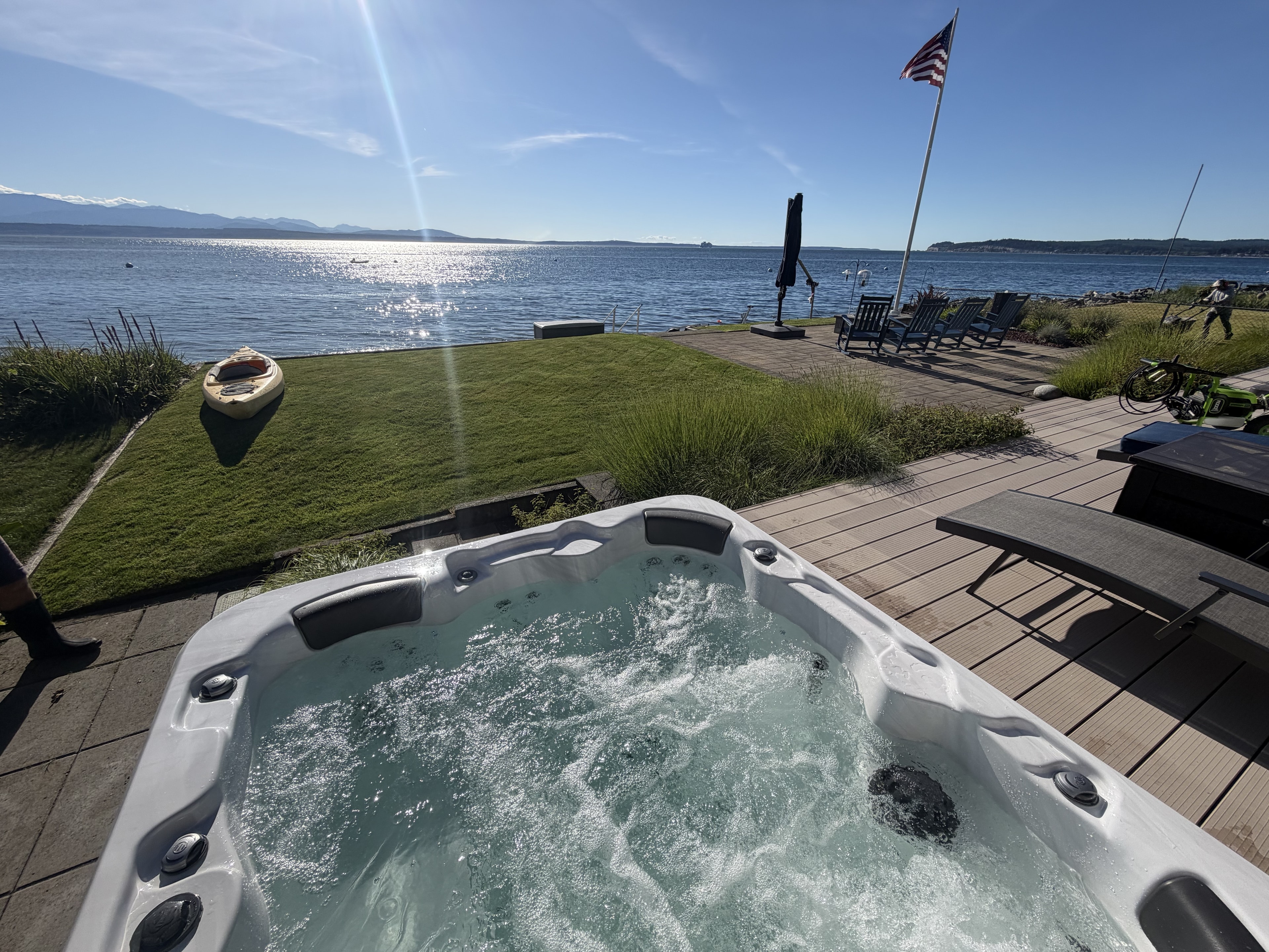 Hot tub with bubbling jets and ocean shoreline view