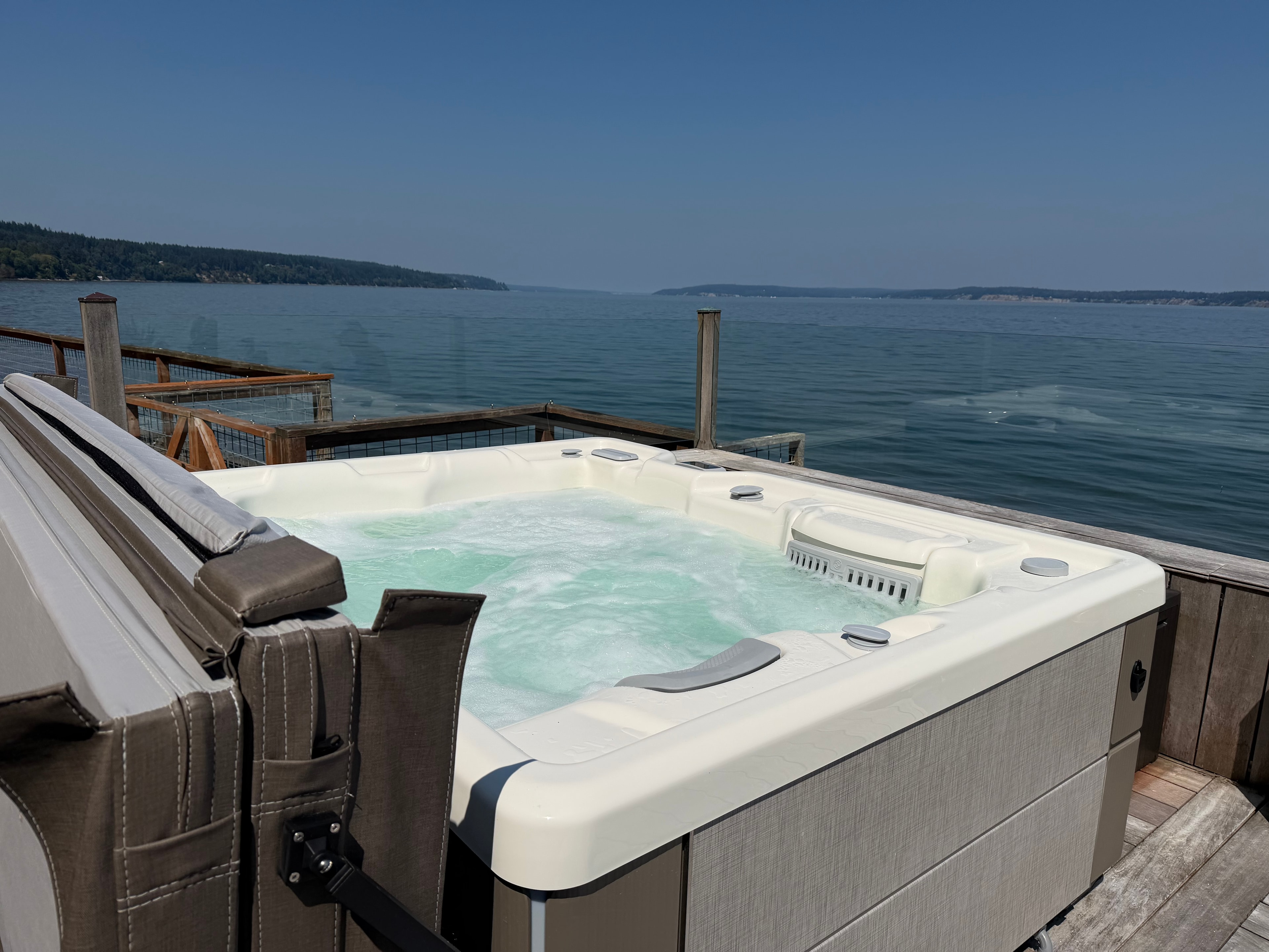 Hot tub with scenic lake and mountain views