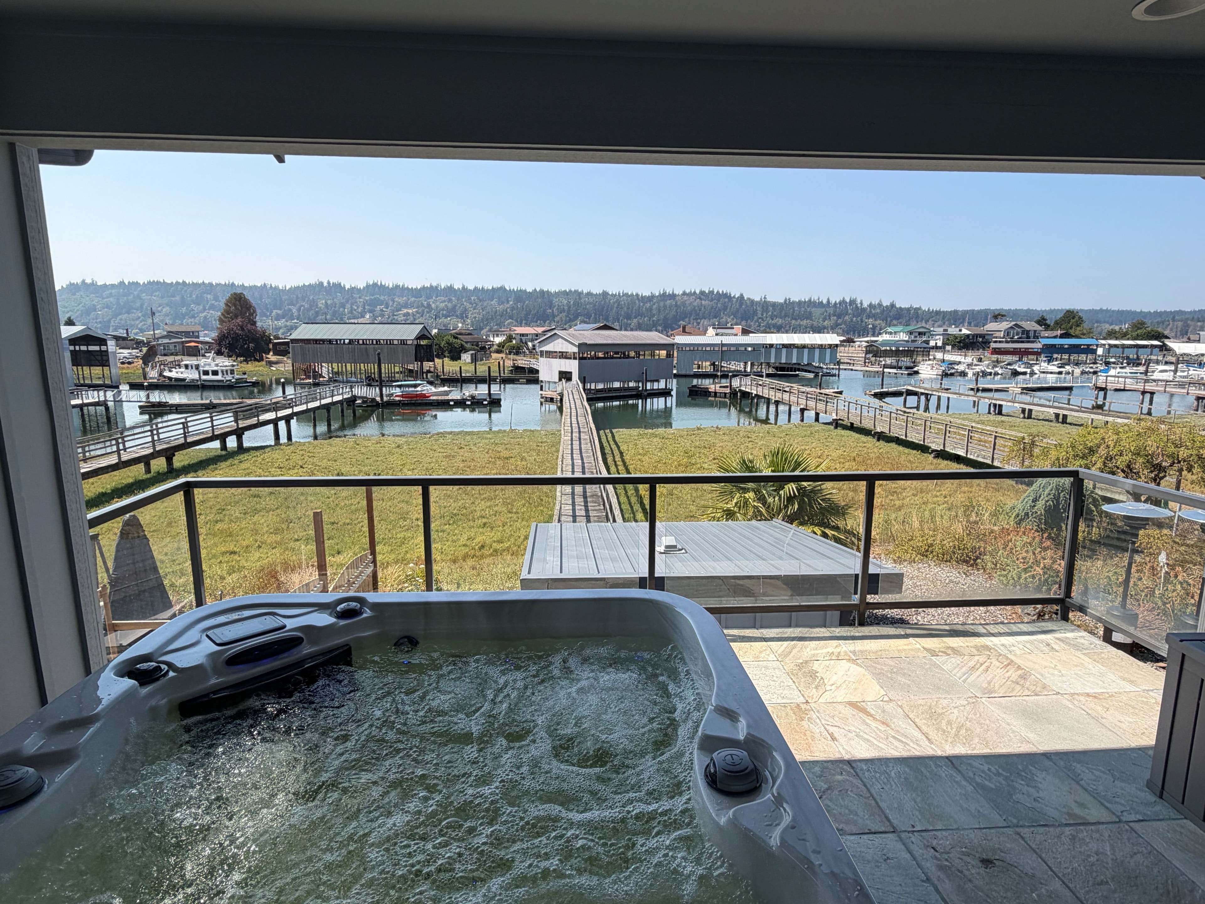 Hot tub with colorful garden and water view